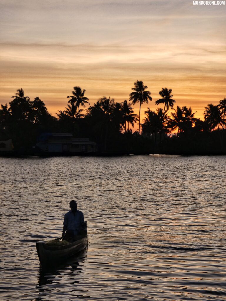 Kerala backwaters travel guide, colourful sunset, local on a boat